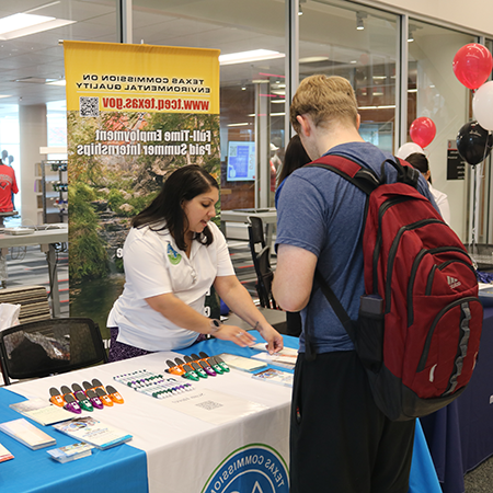 Student talking to a job representative